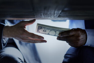 Passing bundles of money under the table